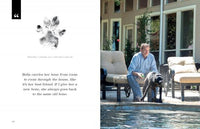 A man lounges poolside, spraying water from a hose at his black Labrador beside him. Enjoy outdoor moments like these in "At Home with Dogs" from Schiffer Publishing, Ltd.—the perfect inspiration for dog lovers.