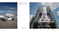 A vintage BMW race car rests on cobblestones in snowy mountains. Next, an automotive photographer captures a BMW Formula 1 car before the Petronas Twin Towers—scenes featured in "Inside Formula 1" by Schiffer Publishing, Ltd.