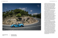A blue McLaren from Schiffer Publishing, Ltd. races along a winding mountain road bordered by trees and rocks under a clear sky, its speed emphasized by motion blur. Text columns are visible on the image’s right side.